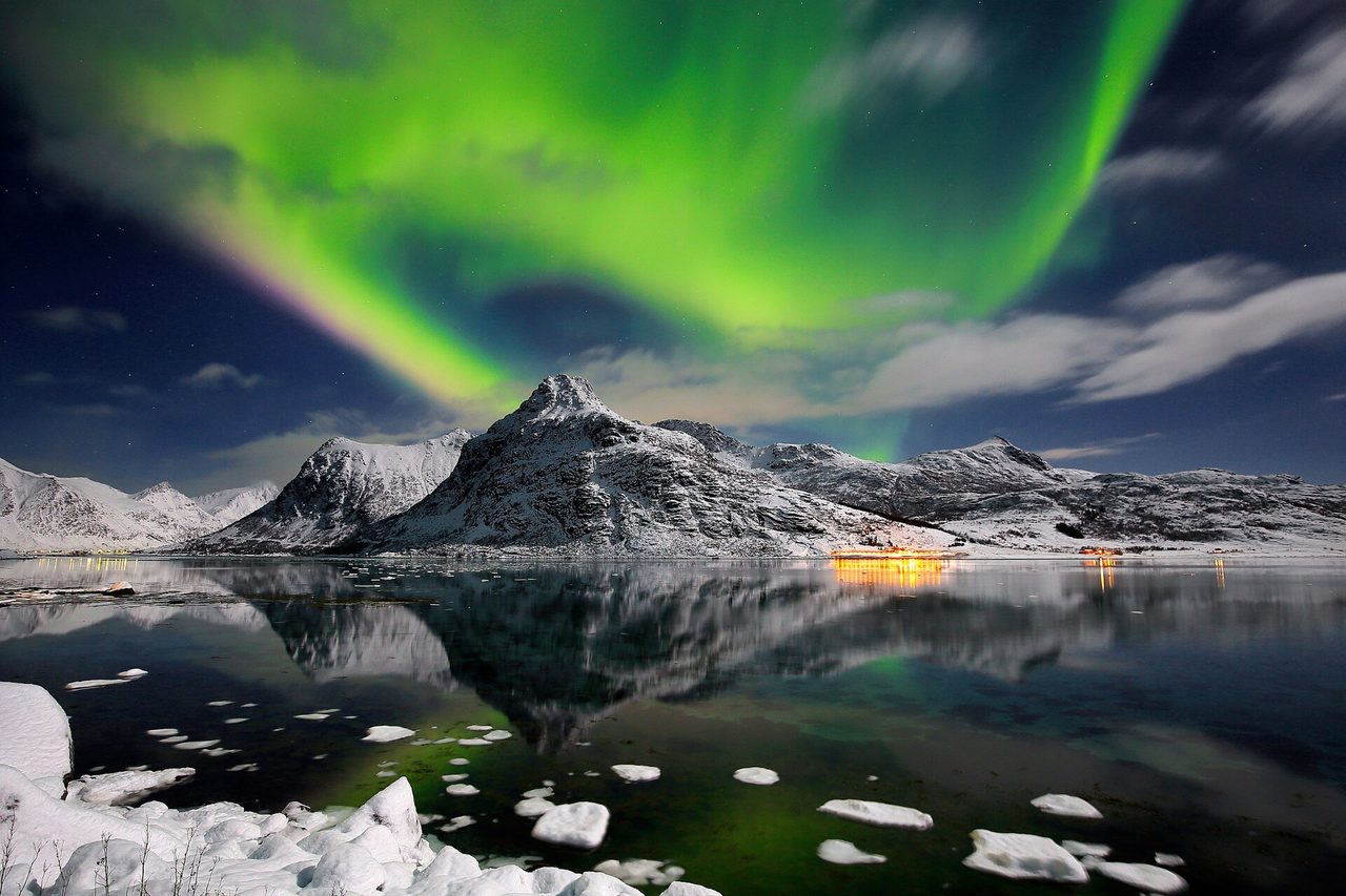 The northern lights over the peaks of the Lofoten Islands