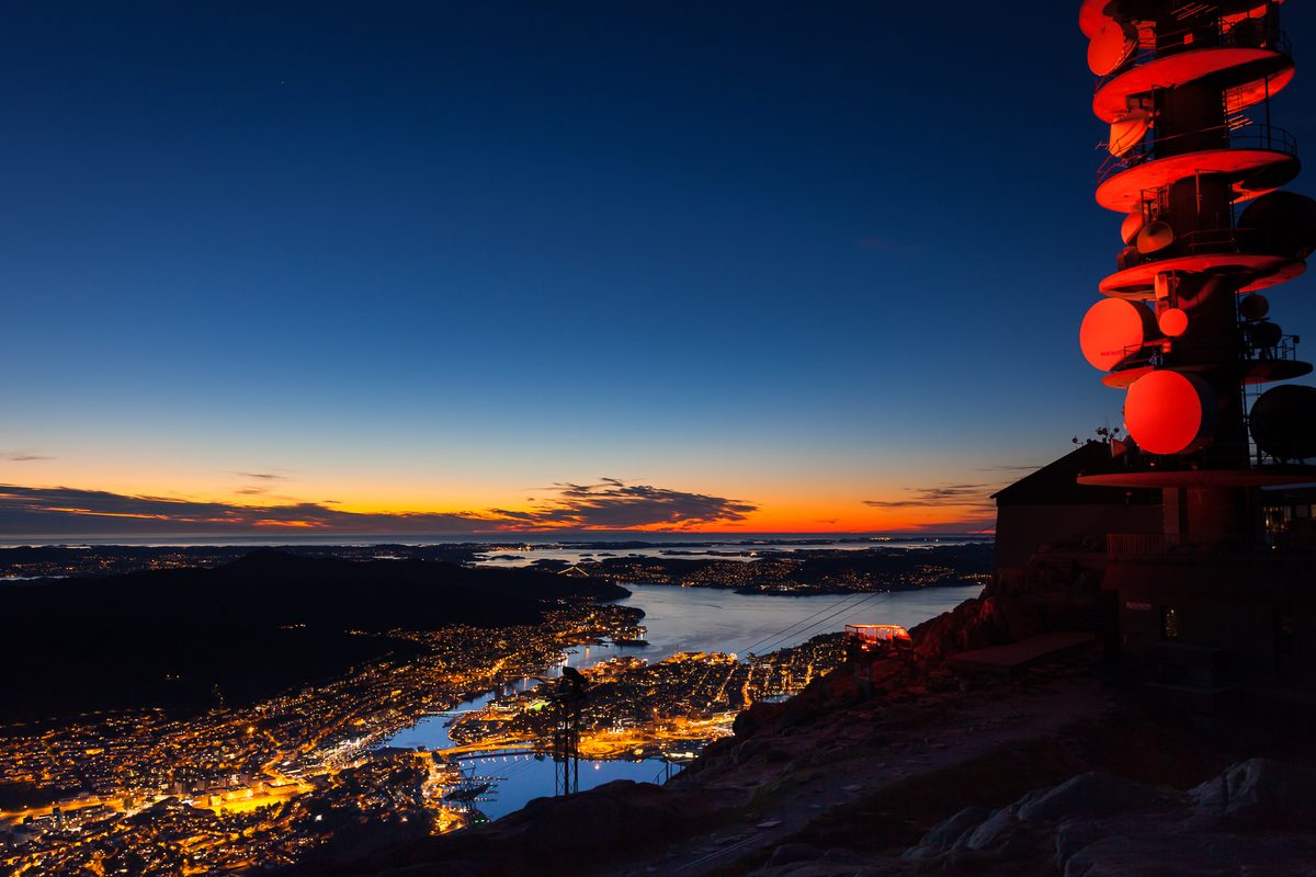 The Ulriken cable car and Bergen's city lights at dusk, seen from the highest of the seven mountains