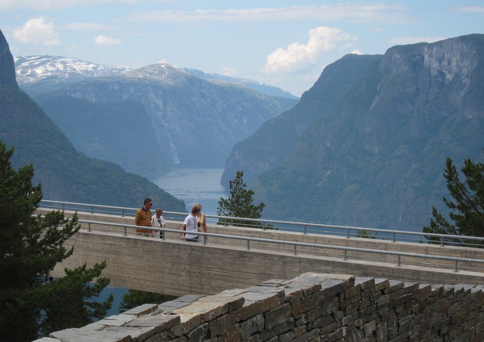 A traveler at the Stegastein viewpoint above Aurlandsfjord; our Norway travel tips cover planning, money, weather and getting around