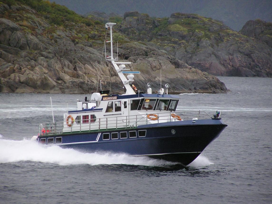 A fjord sightseeing boat cruising Norway's narrow fjord country near Flam