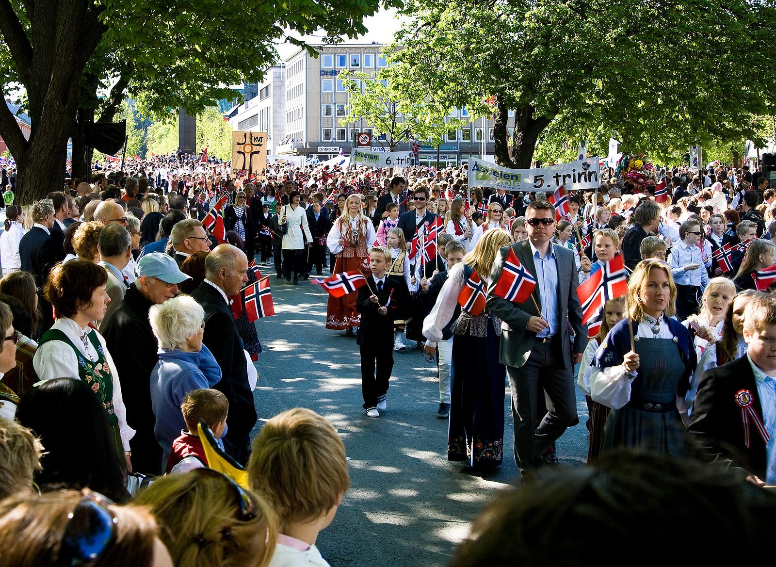 Crowds waving Norwegian flags at a 17 May Constitution Day children's parade in Trondheim