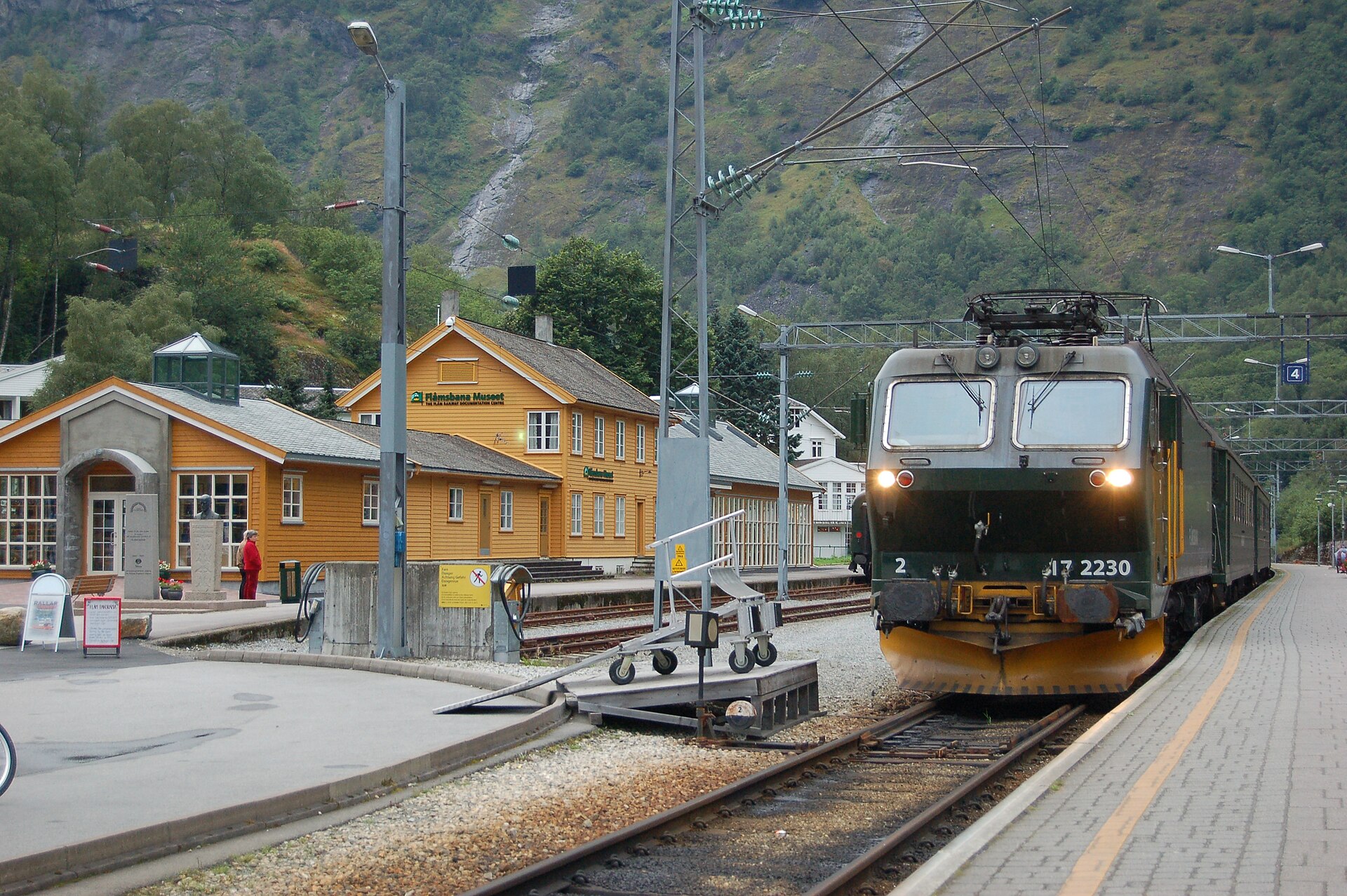The green Flåm Railway train waiting at Flåm station in western Norway