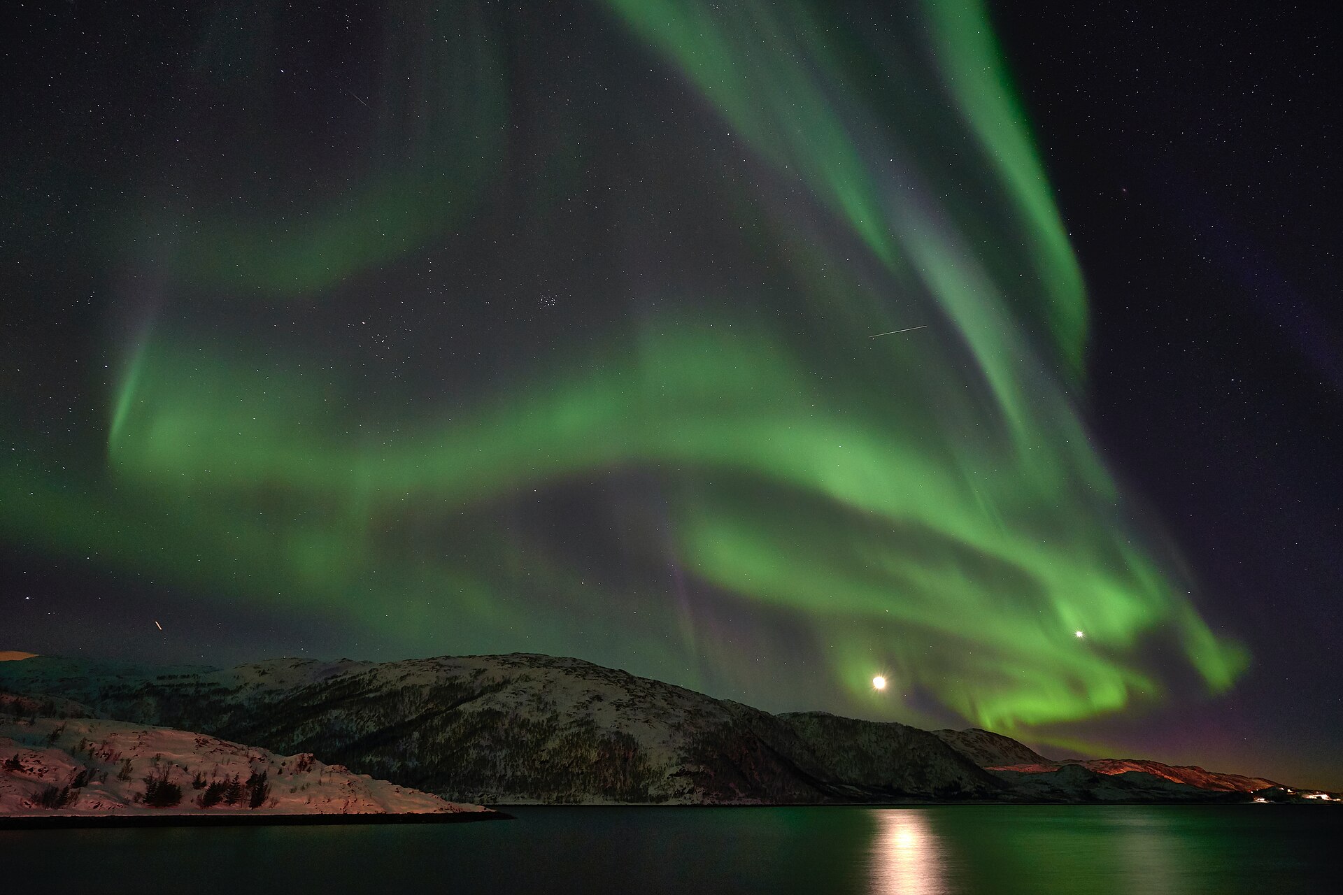 Green northern lights over the Arctic coast near Tromsø, the top entry on any Norway bucket list