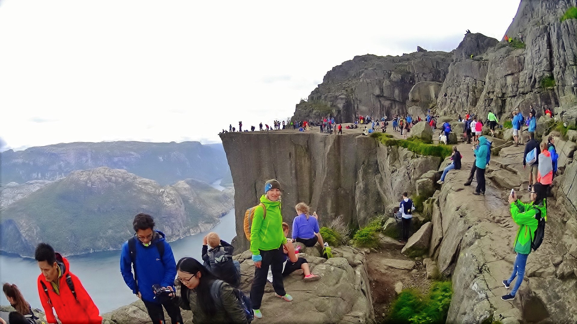 Hikers on the flat top of Preikestolen, Pulpit Rock, above the Lysefjord in Norway