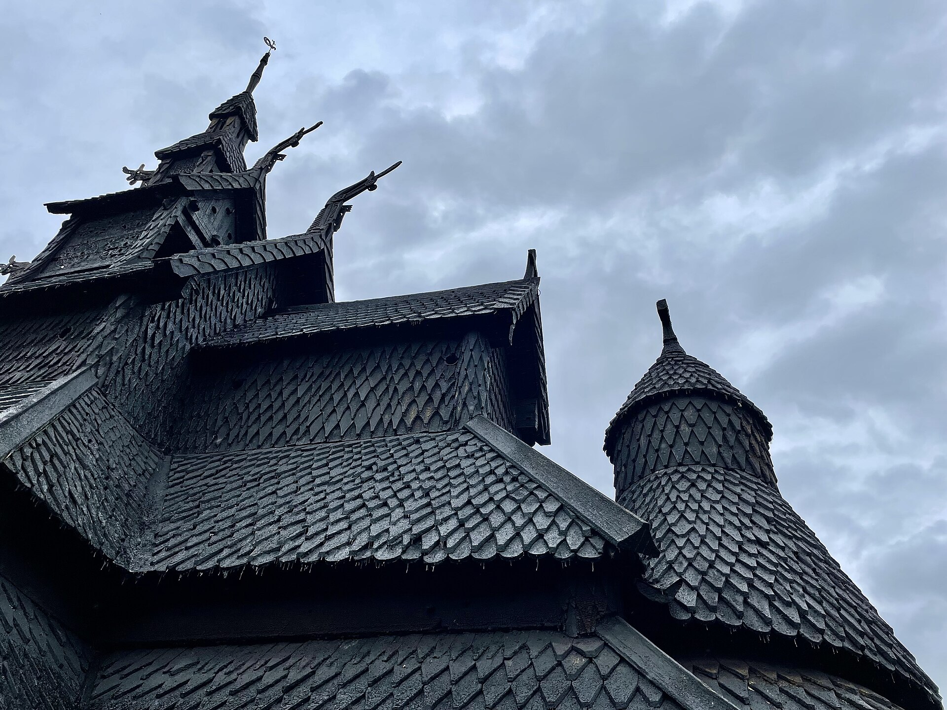 The tiered dark timber roofs and dragon heads of Borgund stave church in Lærdal, Norway